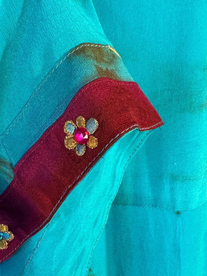 Sleeve detail of blue dip dyed vintage silk with dark red velvet trim and floral embroidery 