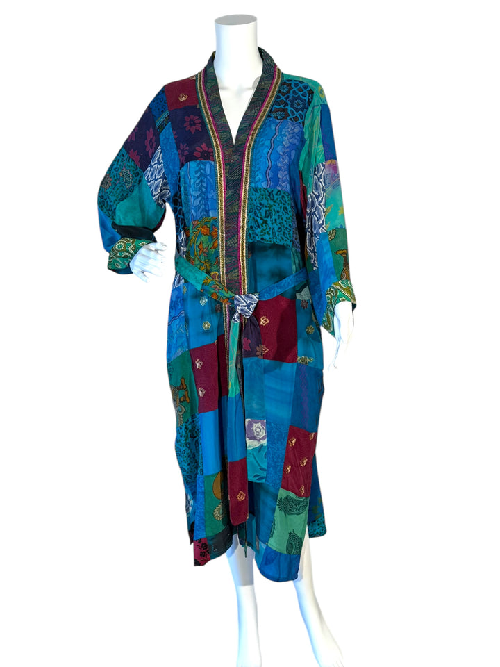 Front view of multi fabric kimono with tie belt and gold edge trim in blues and greens