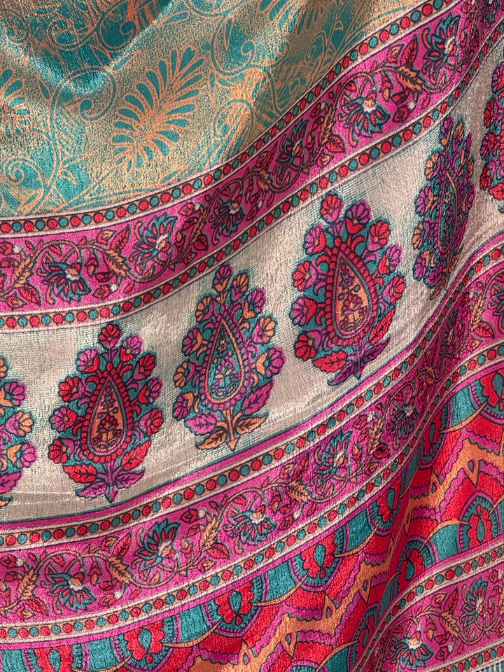 Close-up of a colorful blue green paisley patterned vintage silk blend.