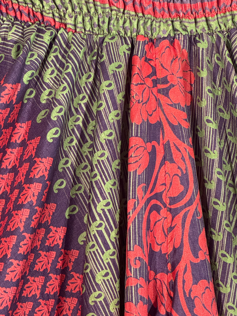Close up of purple, green and red silk blend vintage fabric