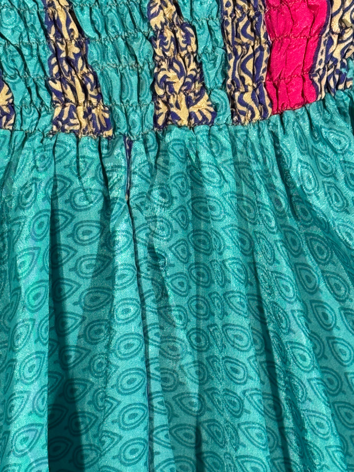 Teal fabric with paisley pattern and colorful border