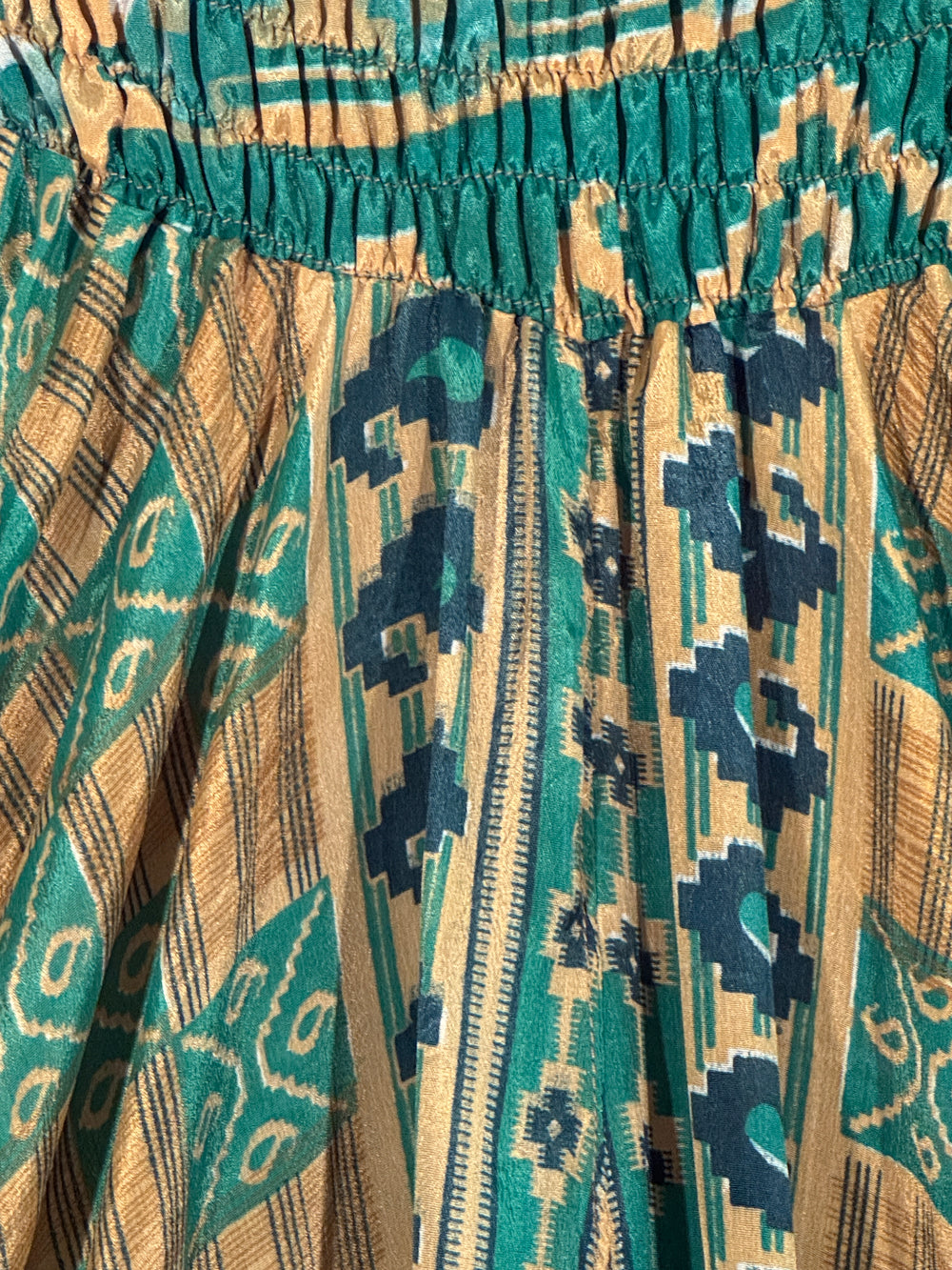 Close-up of patterned silk blend with blue, beige, and green colors.