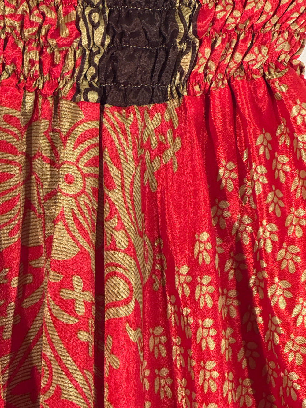 Red and gold silk blend fabric with brown trim