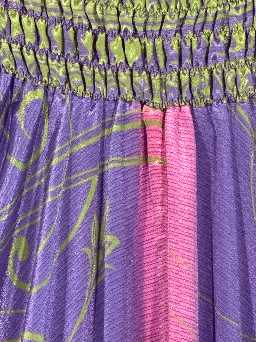 Close-up of purple silk blend with green  and pink patterns
