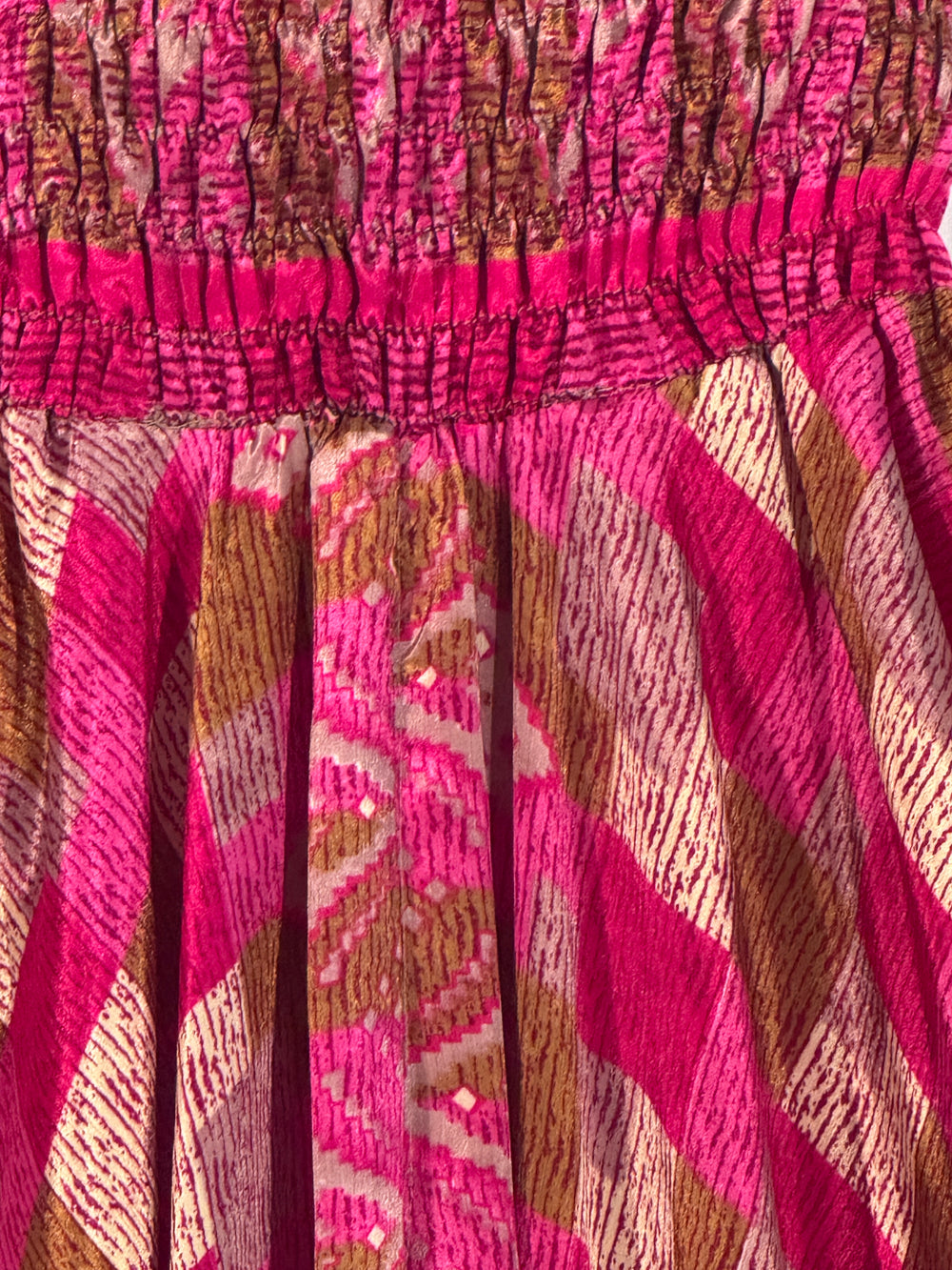 Close-up of pink and brown patterned silk blend upcycled fabric