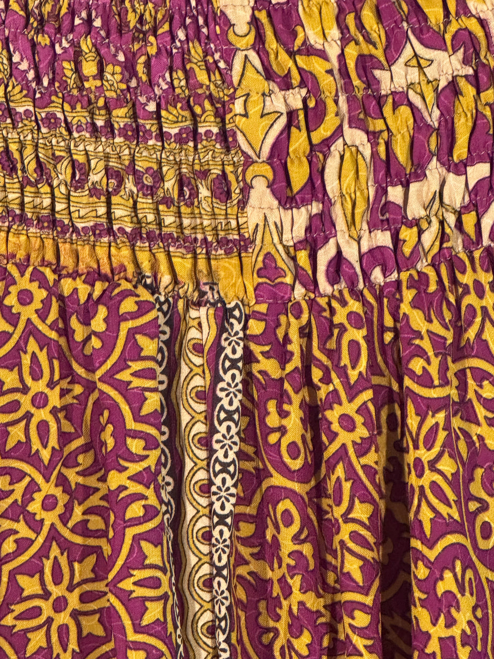 Close up of purple and gold silk blend fabric