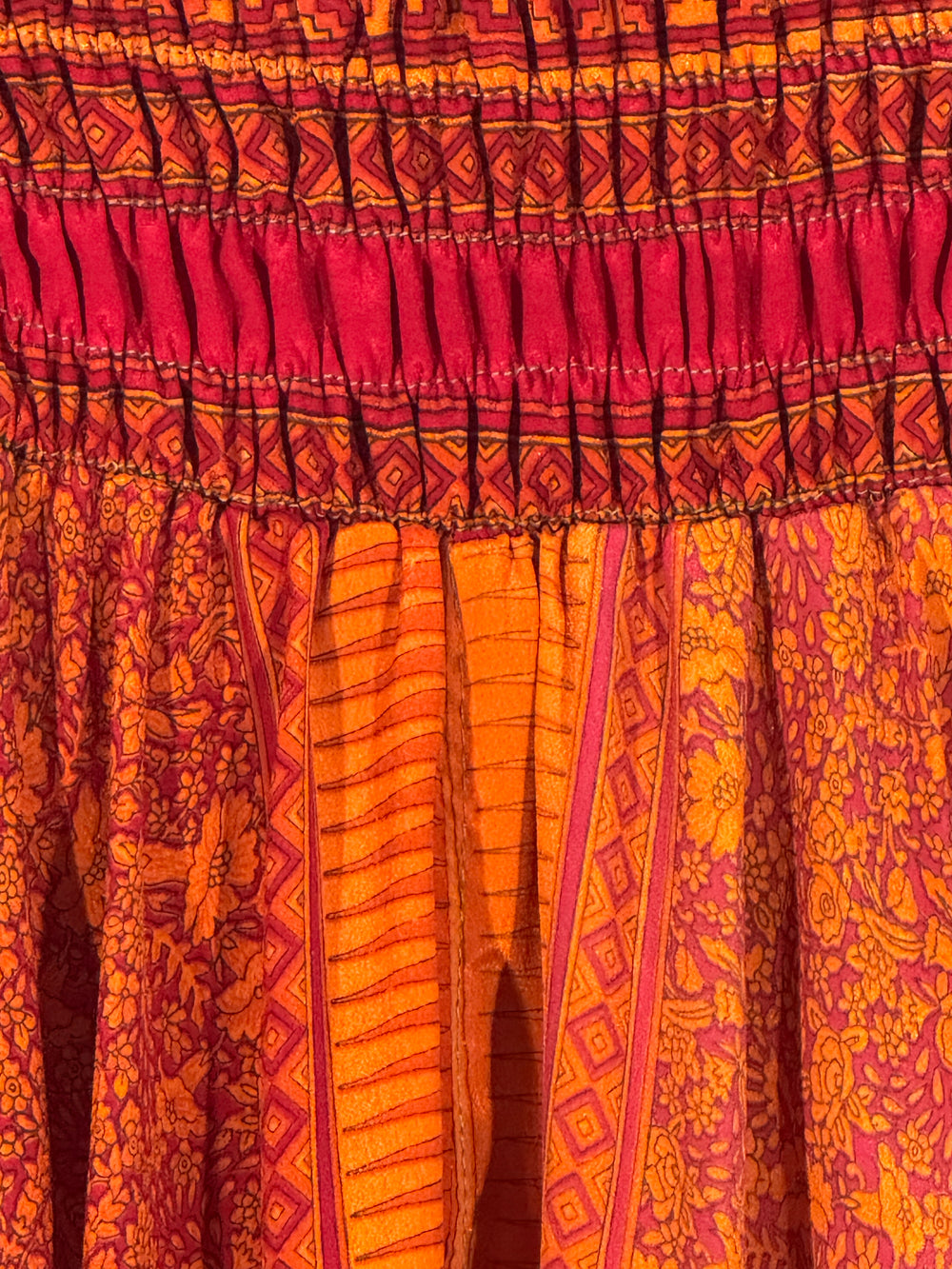Close-up of a patterned fabric with pink and orange colors