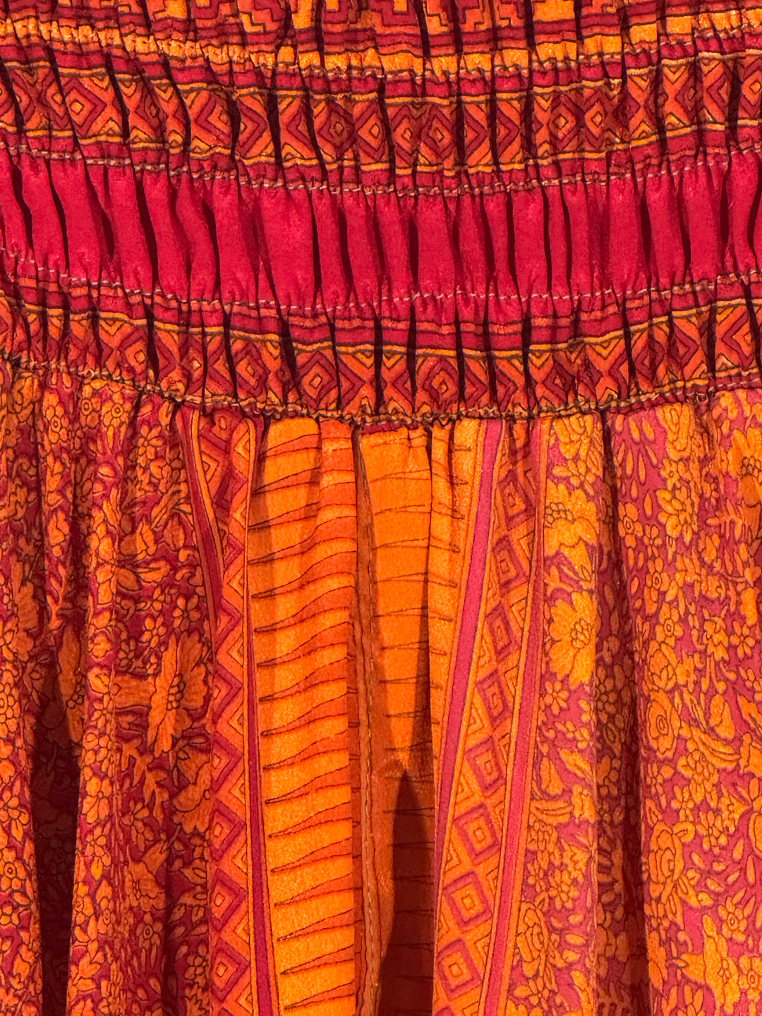 Close-up of a patterned fabric with pink and orange colors