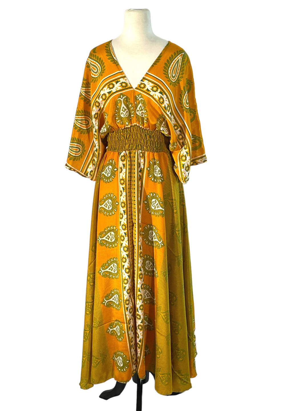 Yellow paisley print boho silk blend dress.  Midi length with V neck front and back and tassel tie.  Flattering elastic gathering under bust.