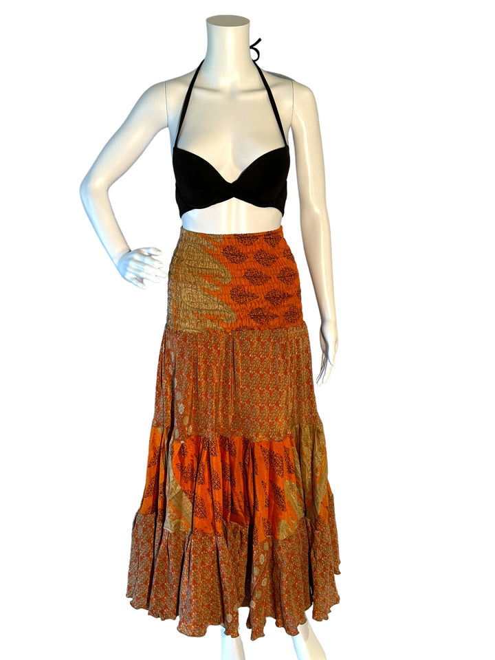 Orange multi print maxi skirt in gathered tiers.  Wide elastic top can become a strapless dress.  Recycled Indian silks.