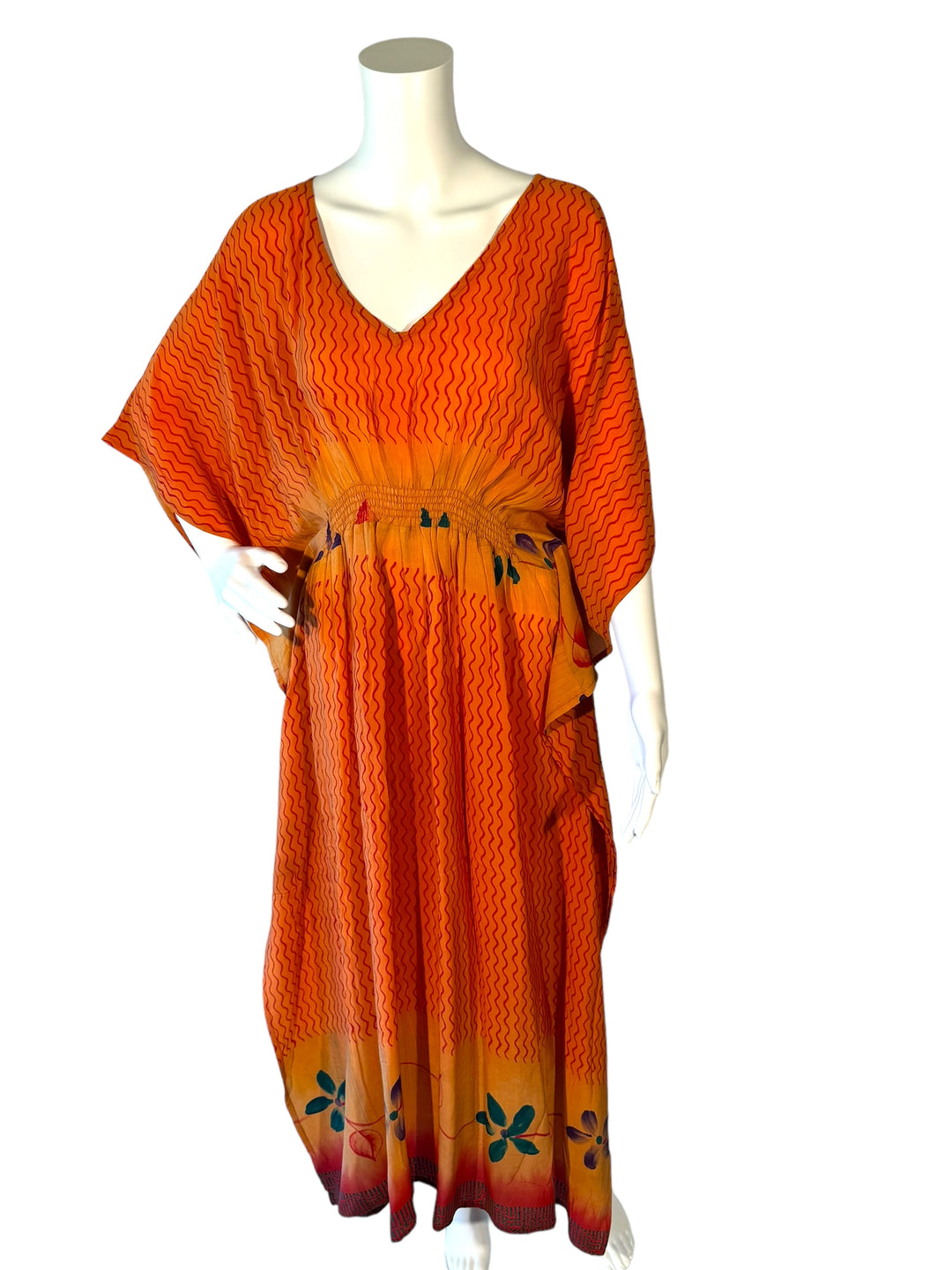 Sustainable orange silk kaftan - patterned print with squiggles and bright florals. V neck maxi length from vintage saree silk. Cold water washable. Easy to style and light and airy to wear.