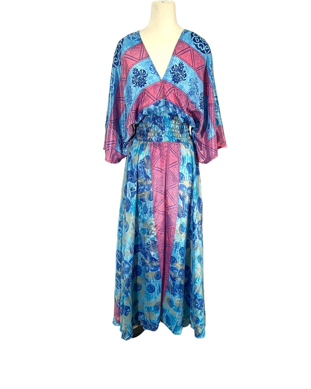 Blue and pink floral print boho silk blend dress.  Midi length with V neck front and back and tassel tie.  Flattering elastic gathering under bust.