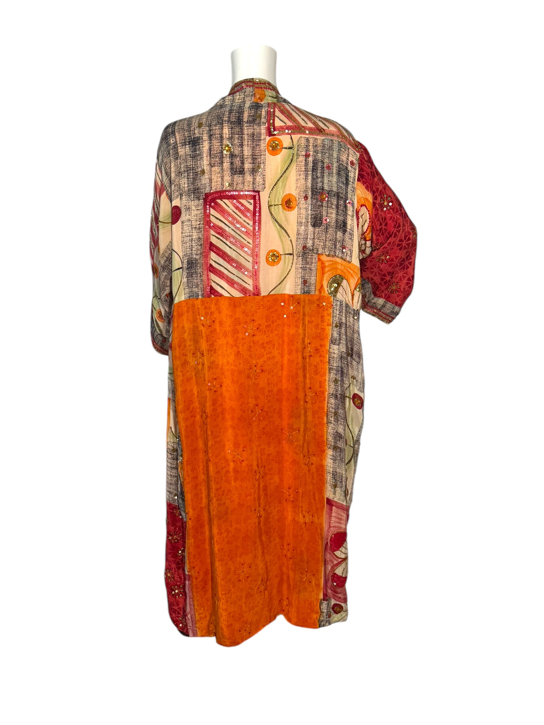 Outside back view of reversible kimono in orange and multi color graphic print with bright sequin embroidery