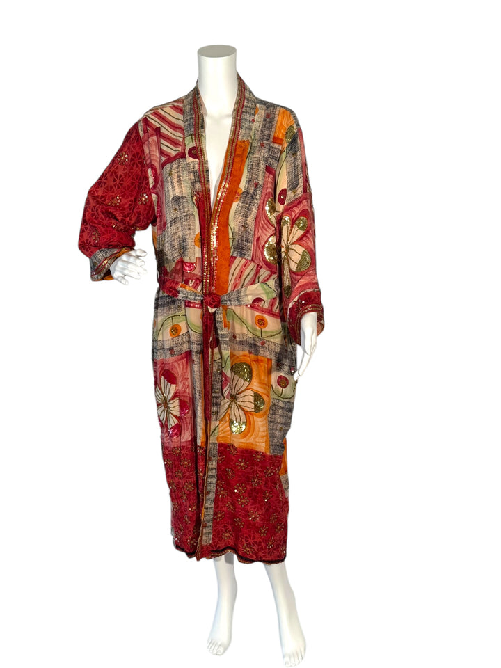 Outside front view of reversible kimono in orange and multi color graphic print with bright sequin embroidery and red borders