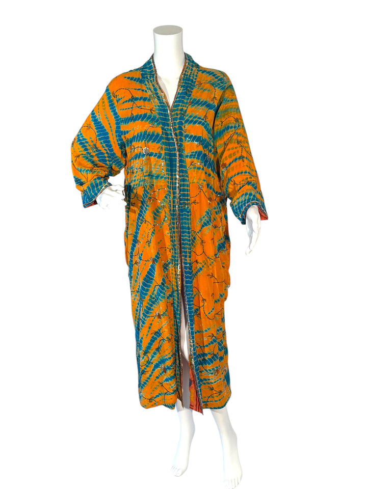 Front outside view of reversible kimono in orange and blue dip dye with all over colored embroidered sequins without tie belt