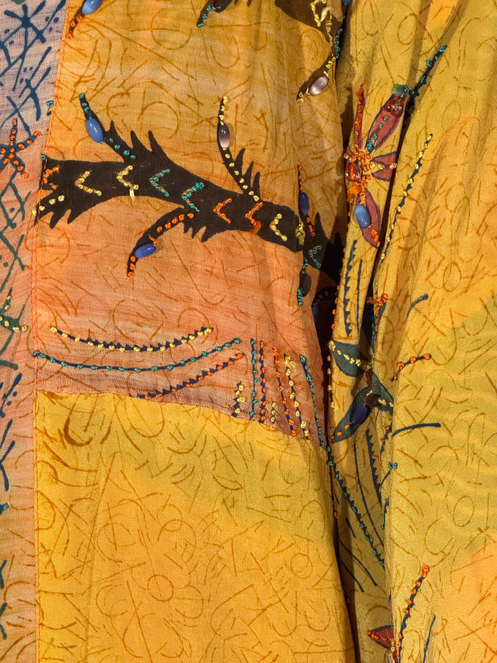 Close view of vintage silk yellow with pattern and beaded embroidery