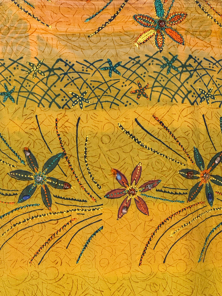 Close detail of yellow vintage silk with embroidery