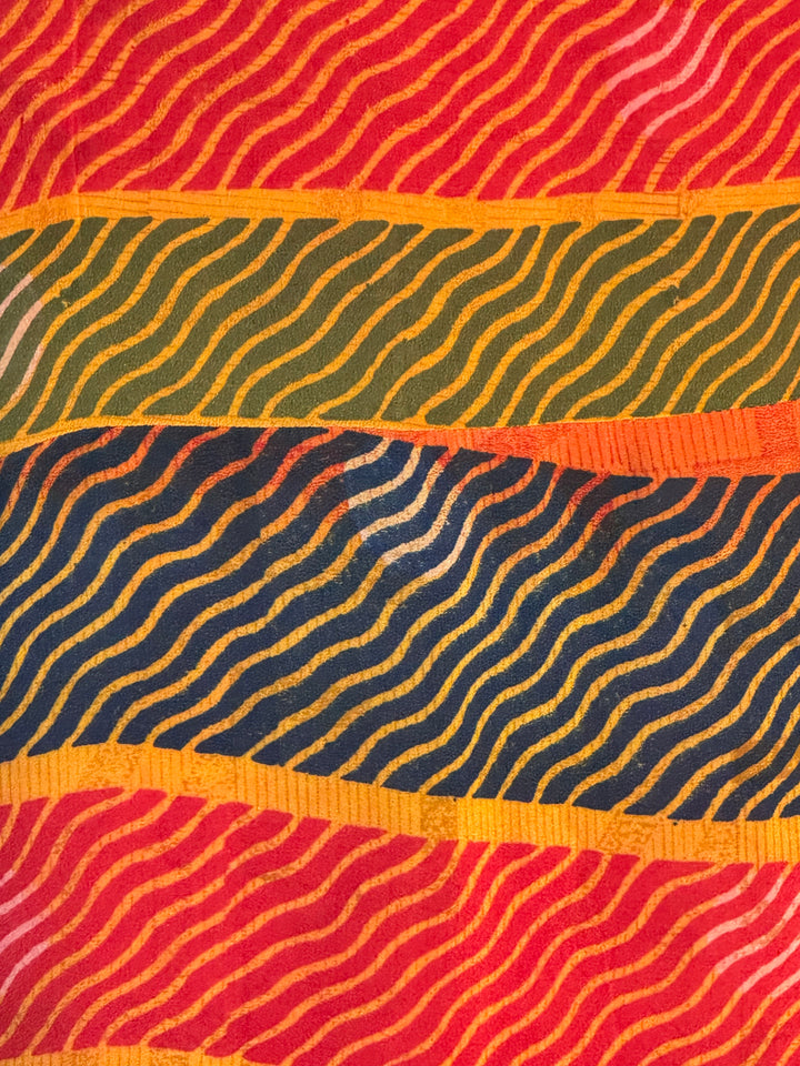 Close view of red, green, yellow and blue pattern in vintage silk used in reversible kimono