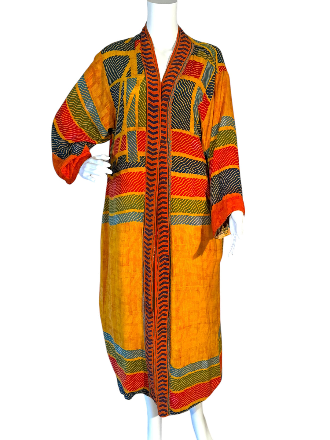 Front view of reversible kimono in multi color geometric pattern