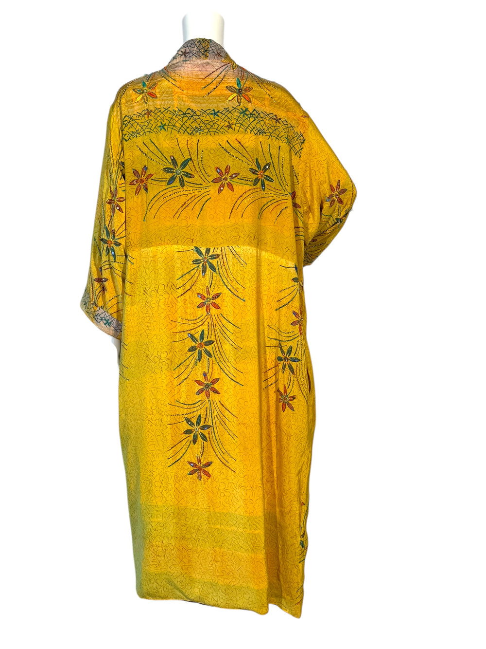 Back view of outside of reversible kimono in yellow pattern with floral embroidery