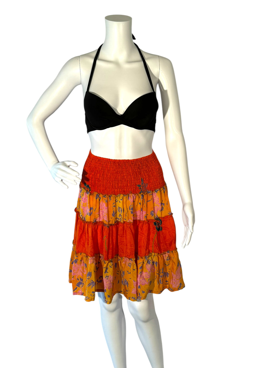 Mannequin wearing vintage silk gathered elastic short tiered skirt in orange with embroidered and print flowers