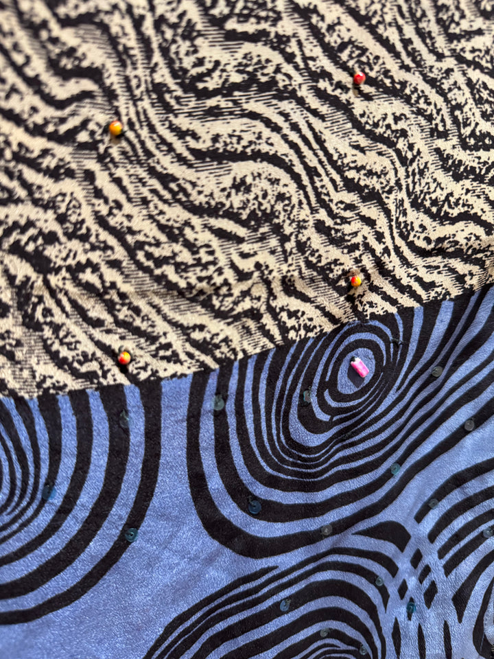 Close view of vintage silk Willow Wrap in Blue, Black and Cream graphic patter with small sequins