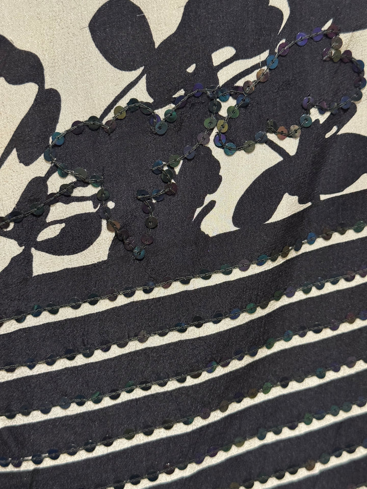 Detail view of vintage silk Willow Wrap in Black, cream and red with floral and stripe print and black sequins