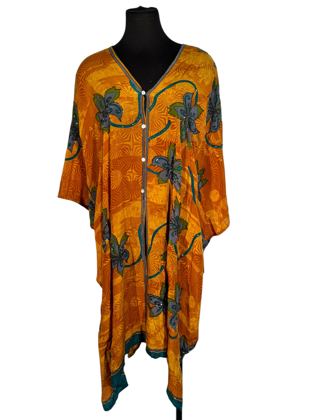 Front view of vintage silk Willow Wrap in gold swirl print with large blue flowers and blue sequins