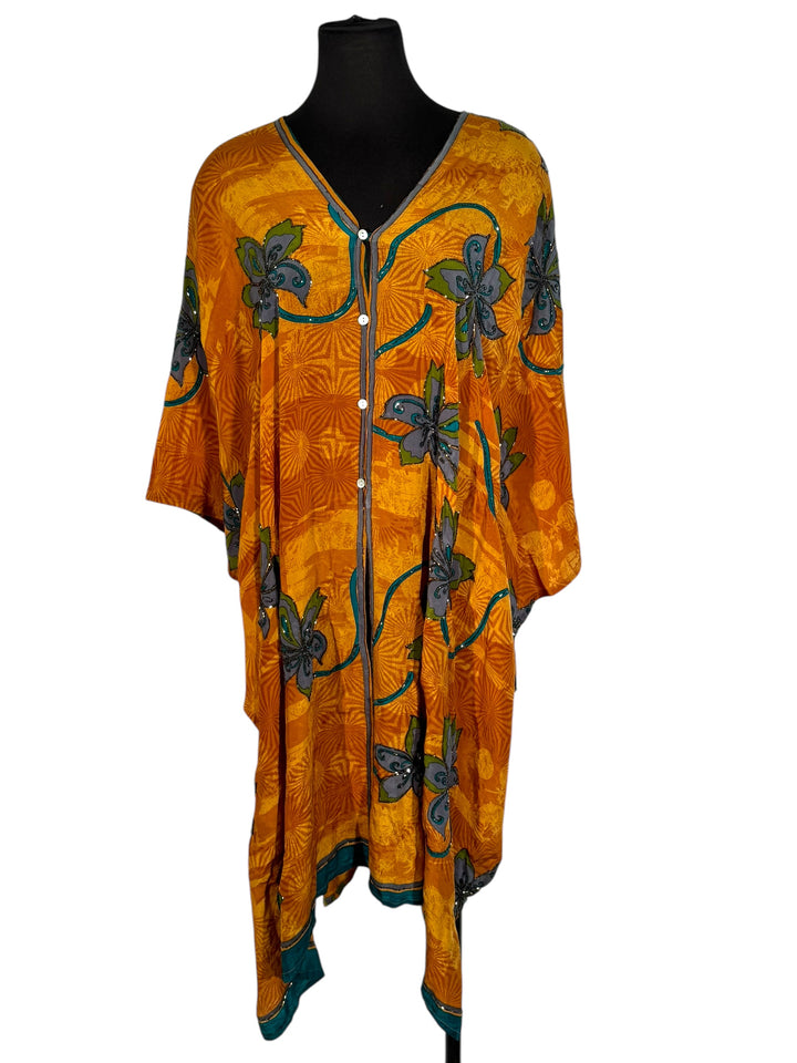 Front view of vintage silk Willow Wrap in gold swirl print with large blue flowers and blue sequins