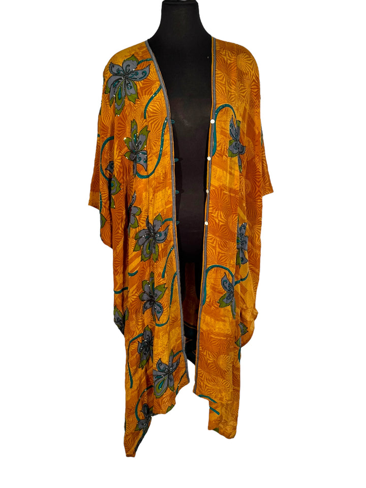 Front view of vintage silk Willow Wrap in gold swirl print with large blue flowers and blue sequins