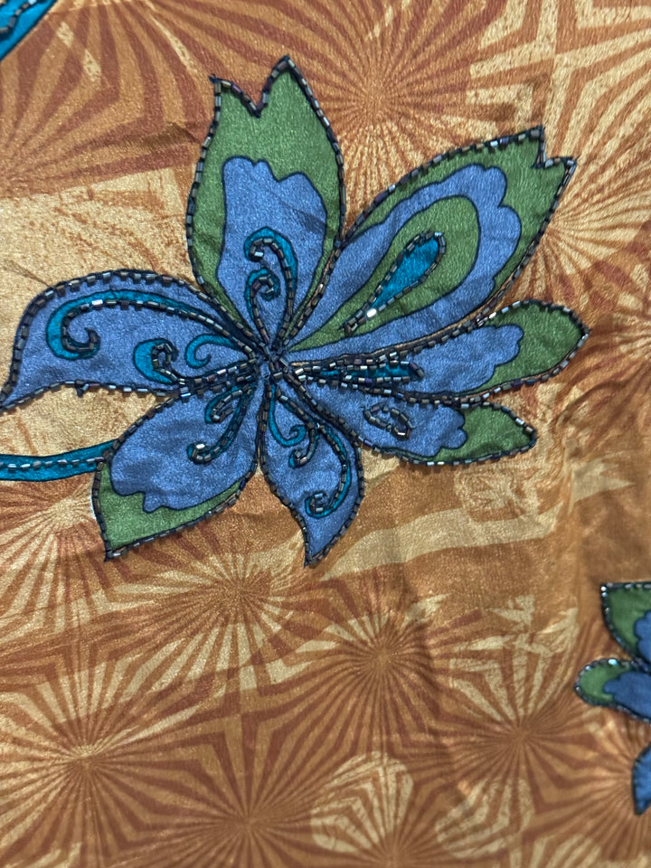 Detail view of vintage silk Willow Wrap in gold swirl print with large blue flowers and blue sequins