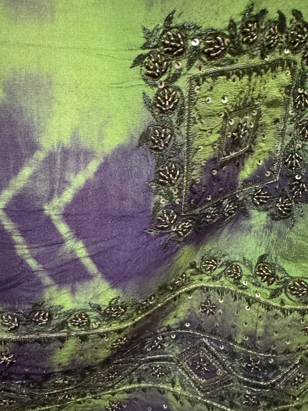 Detail view of vintage silk Willow Wrap in bright green dip-dye with gold embroidery