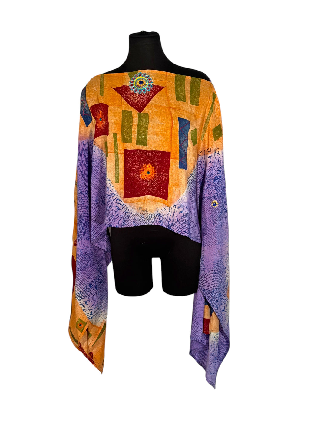 Sideways view of vintage silk Willow Wrap in orange  and purple with geometric print and large floral embroidery with rhinestones