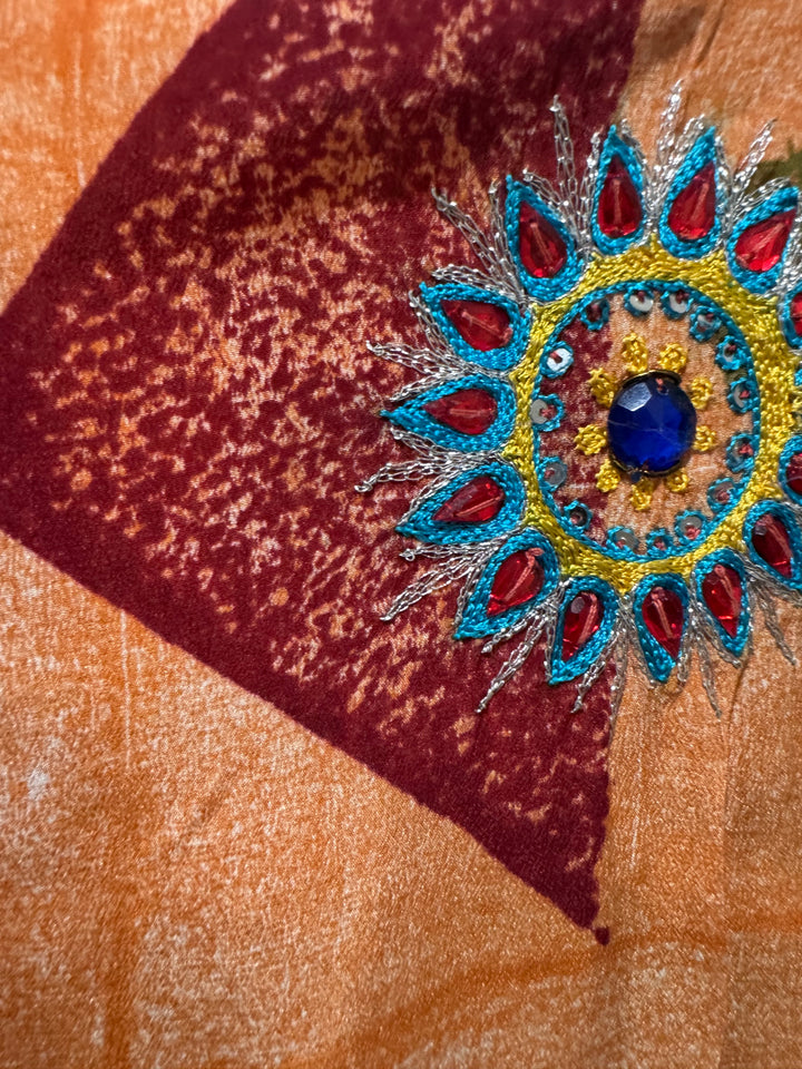 Detail view of vintage silk Willow Wrap in orange  and purple with geometric print and large floral embroidery with rhinestones