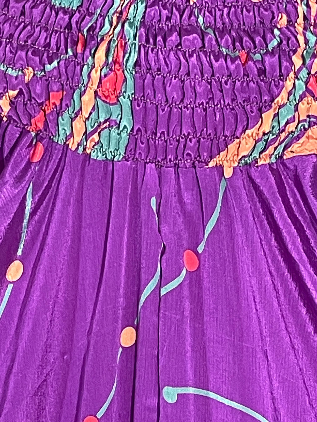 Close up view of purple abstract print on sustainable silk