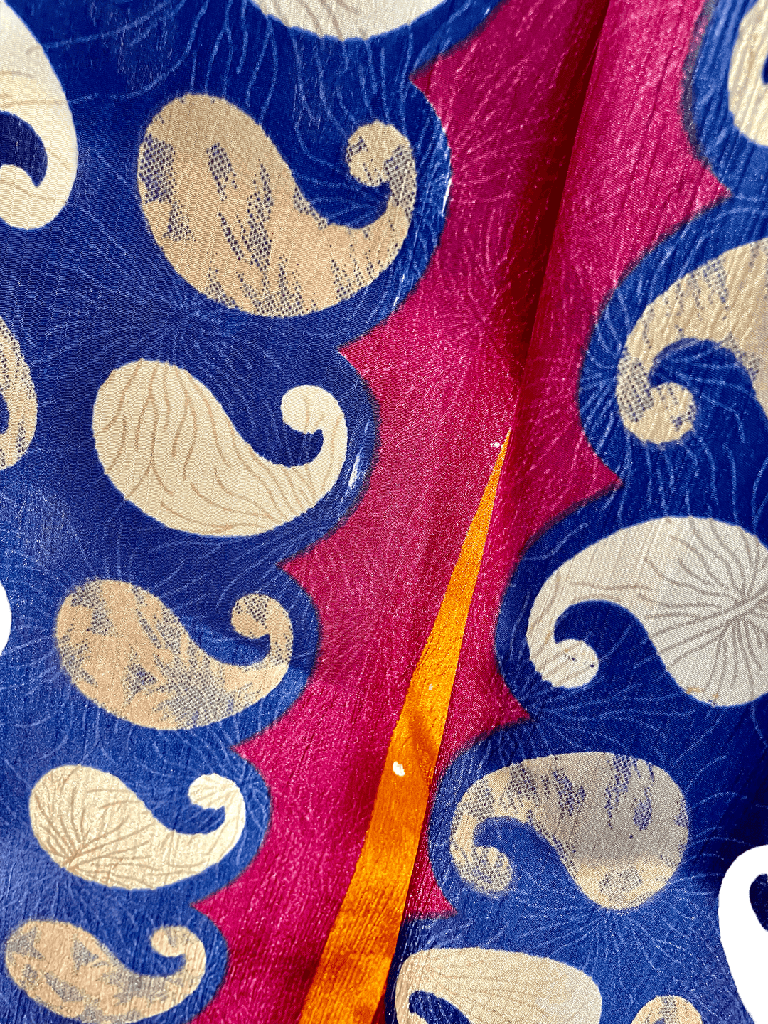 Close up view of navy and gold pattern on sustainable silk fabric